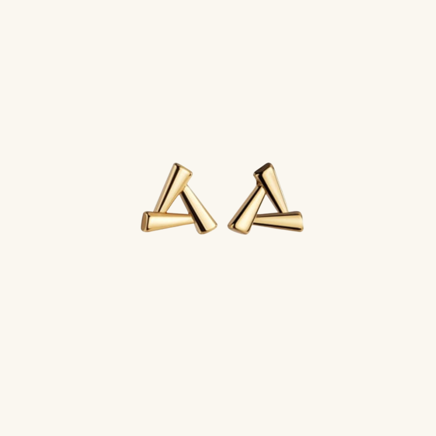 Gold triangle-shaped earrings on a white background