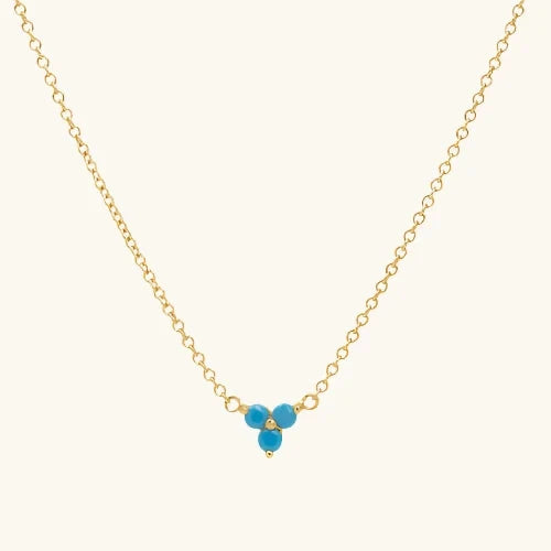 Trinity necklace is like our Lotus flower in blue, on a warm cream background.