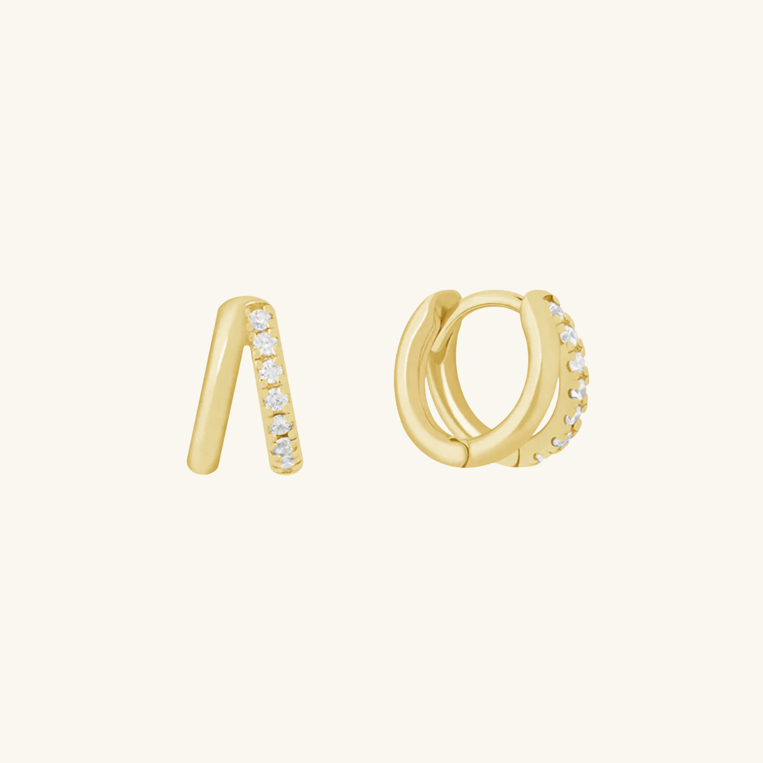 Gold huggie earrings with small CZ on a white background