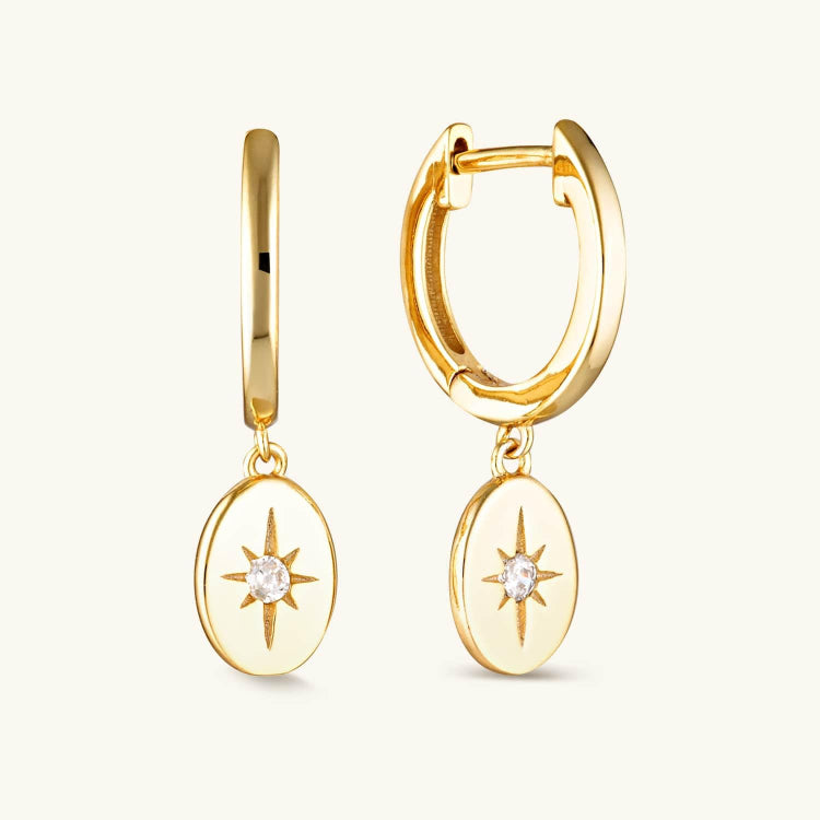 Gold-plated Vesper Huggie Earrings with an oval drop and star center, blending celestial charm with timeless elegance