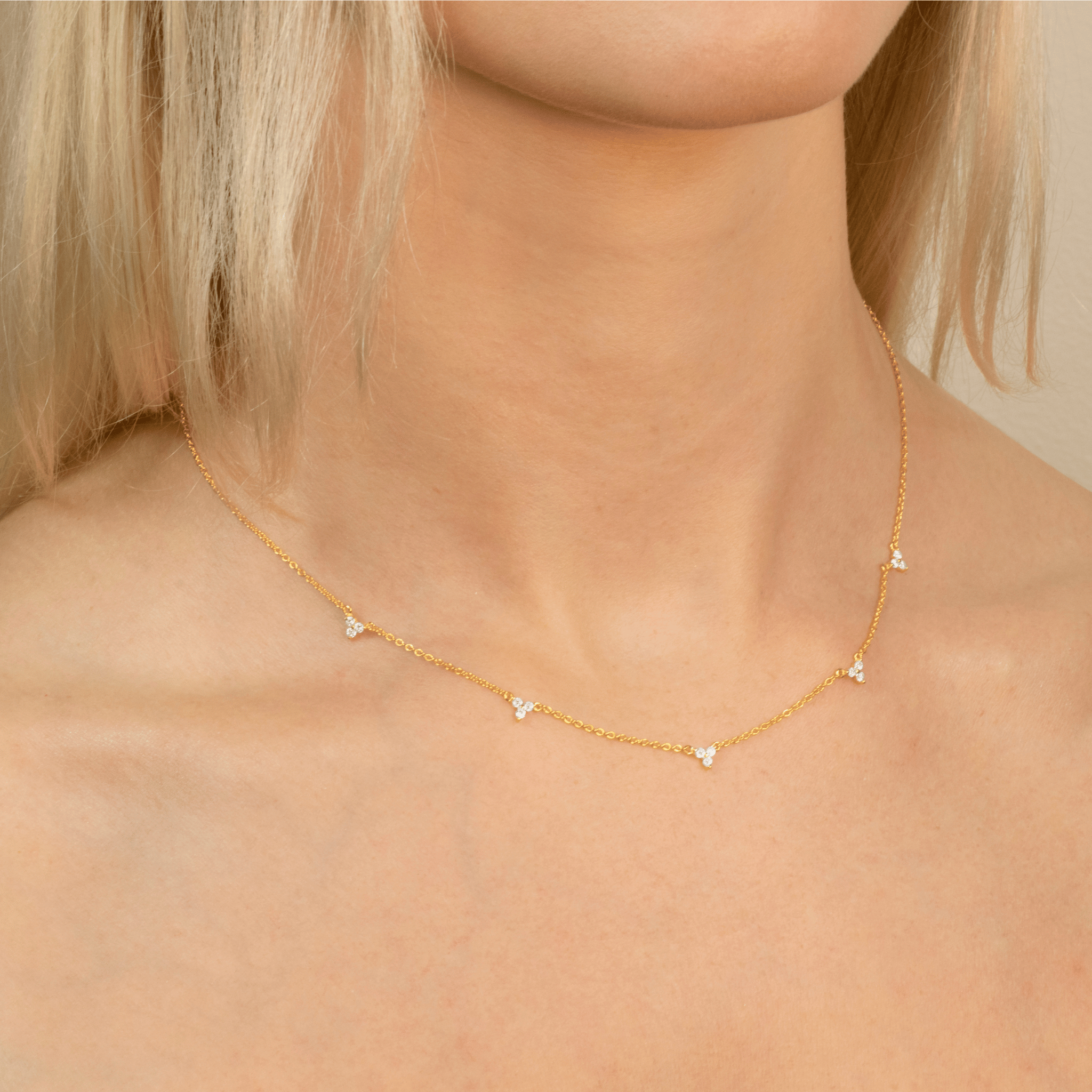 model wears lotus gold necklace