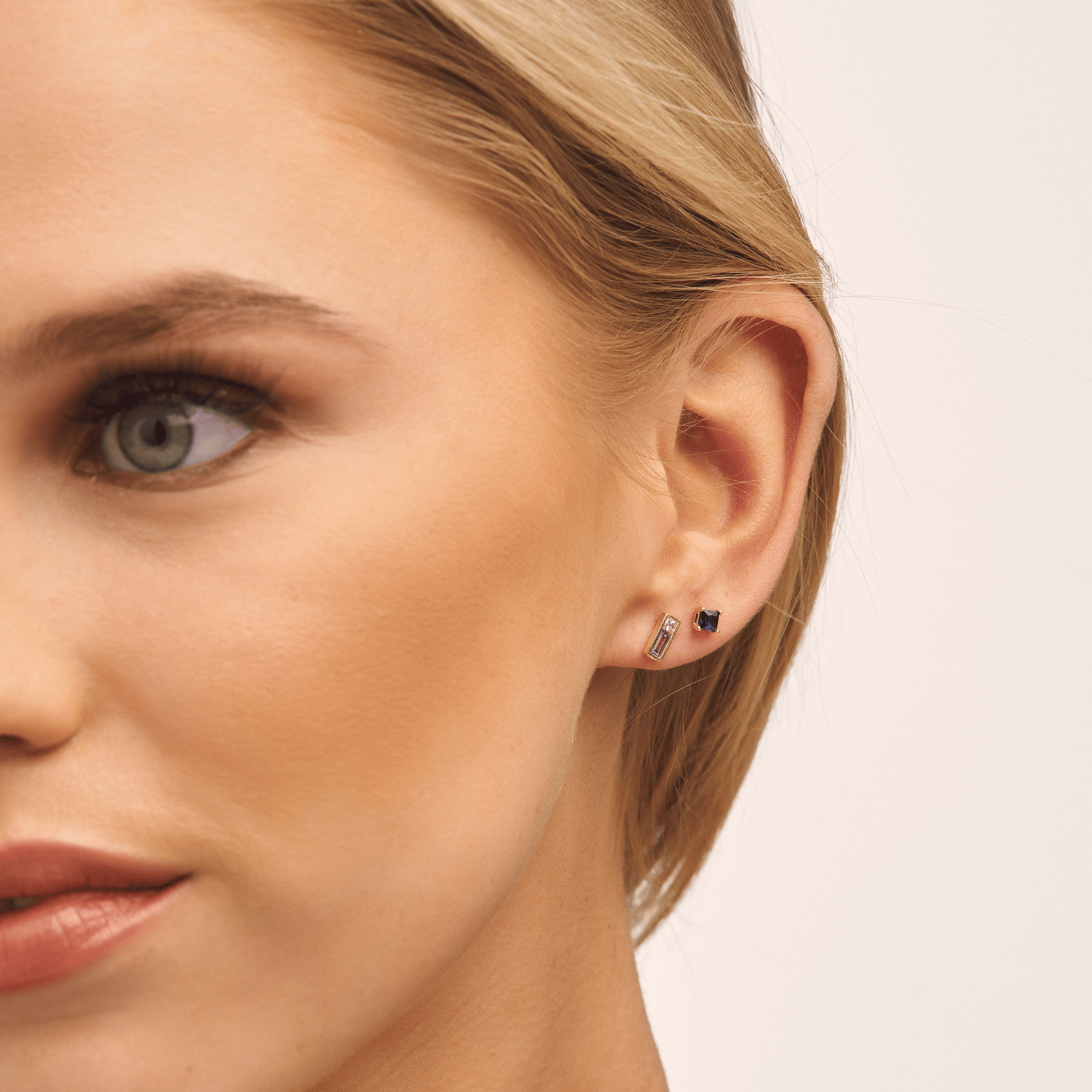 model wearing purple and pink sapphire earrings