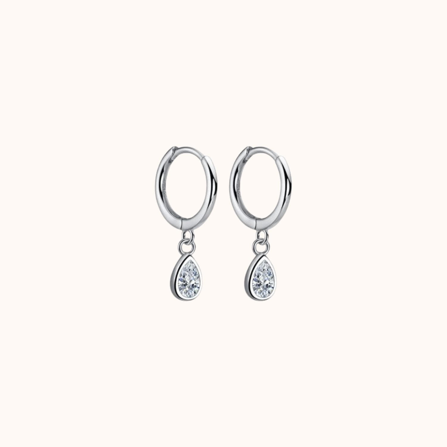 Silver hoop earrings with teardrop-shaped crystals on a white background