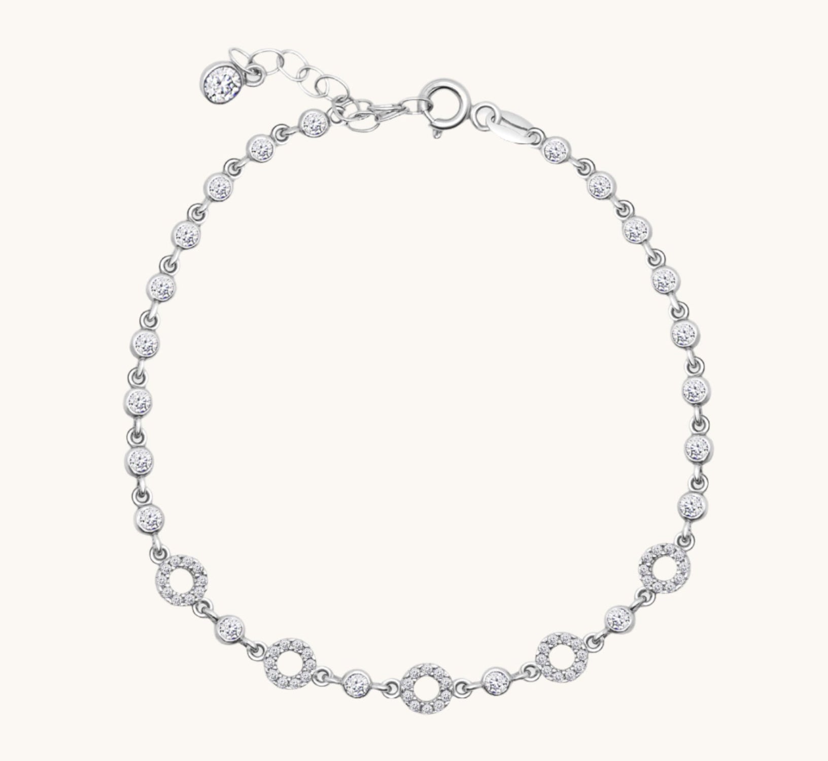 Flat lay of five circle cubic zirconia bracelets, displayed neatly on a neutral background
