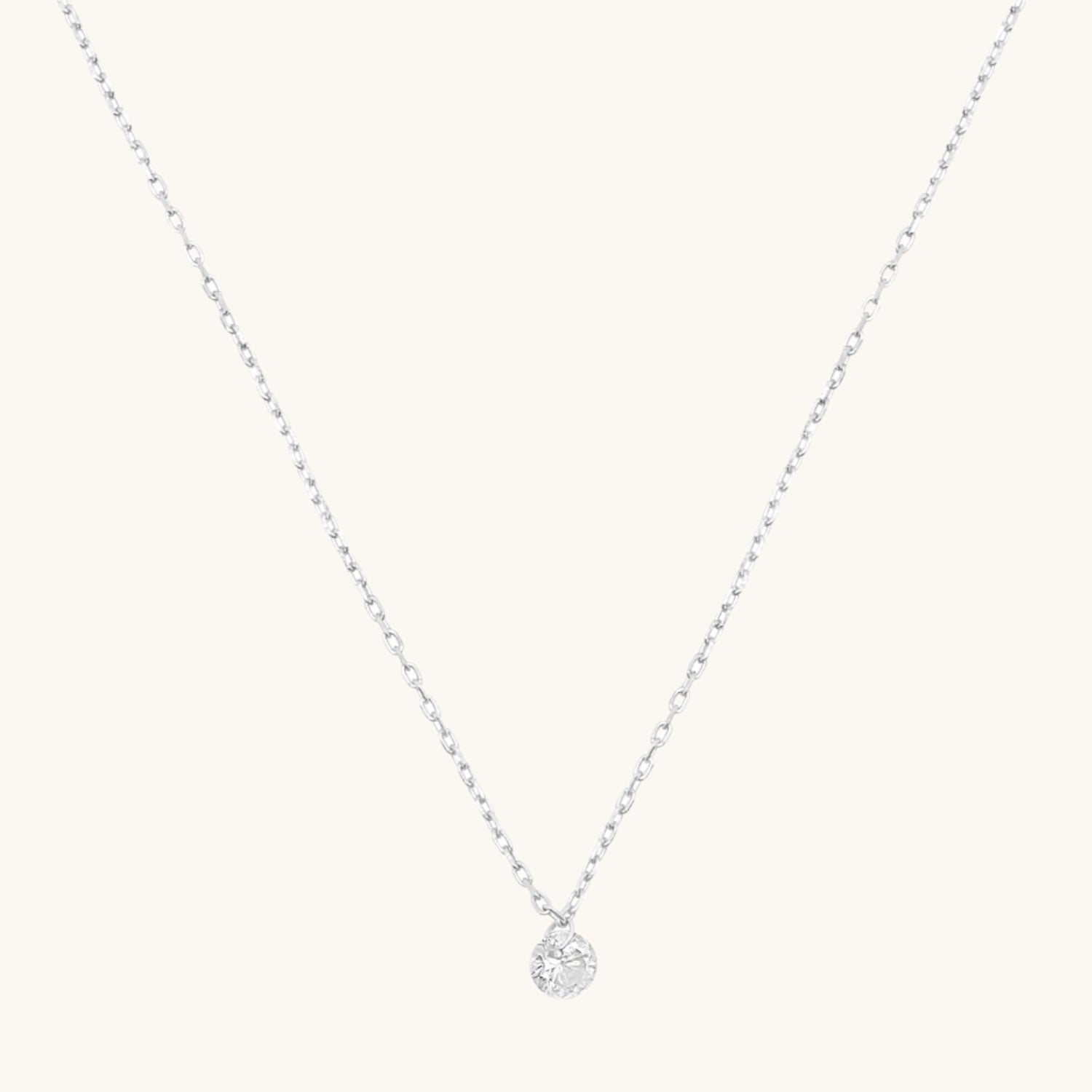 Silver Single cubic zirconia drop necklace on cream background