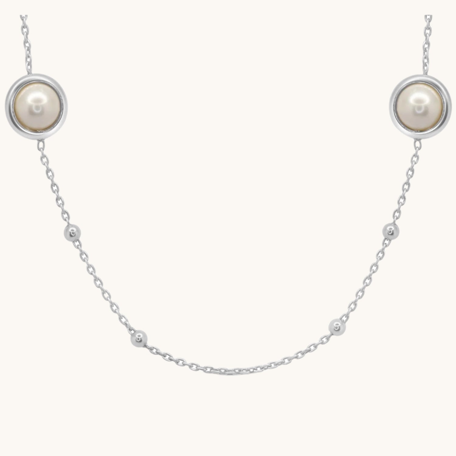Pearl-Encased Bauble-Chain Necklace, shown on cream background