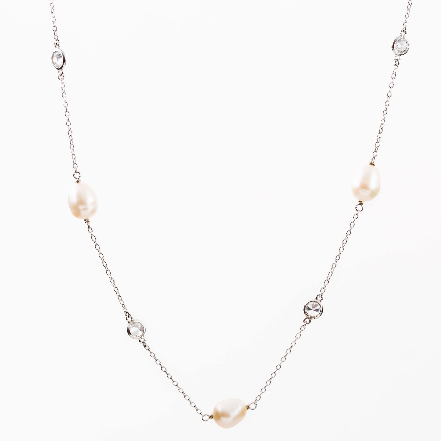 Close up of Sterling Silver necklace with Pearl and Cubic Zirconia along its length.