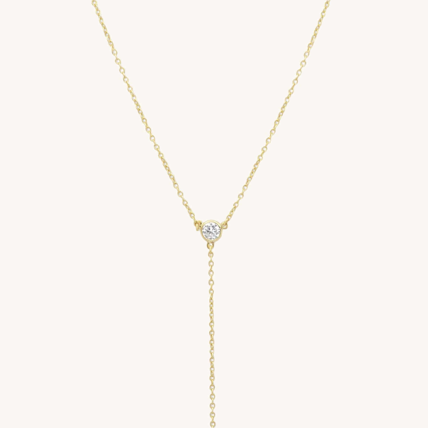 Classic Short Y Necklace in gold plated on a soft cream background
