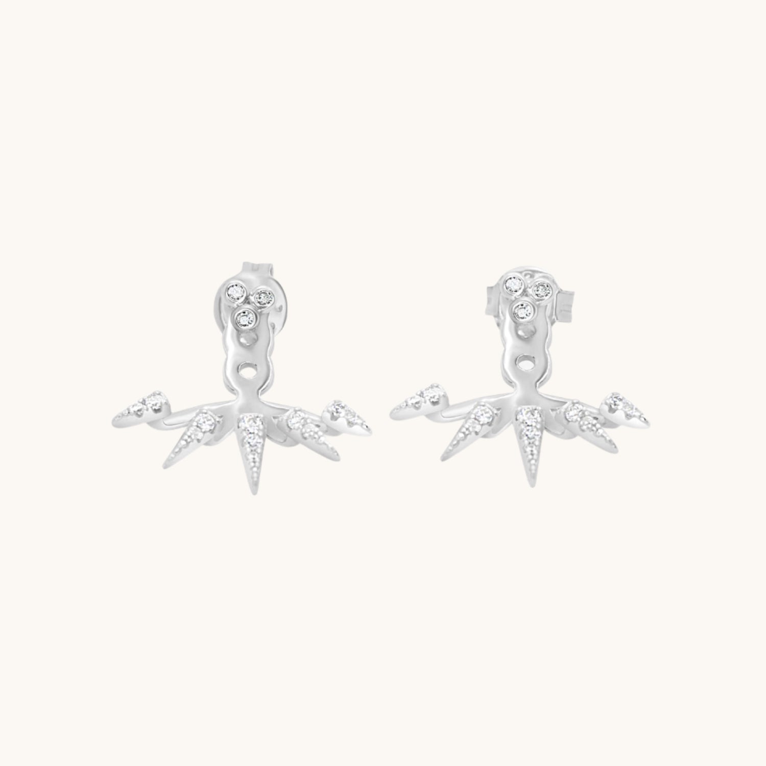 Silver Cubic Zirconia Earrings Featuring Decorative Cuff displayed on cream background
