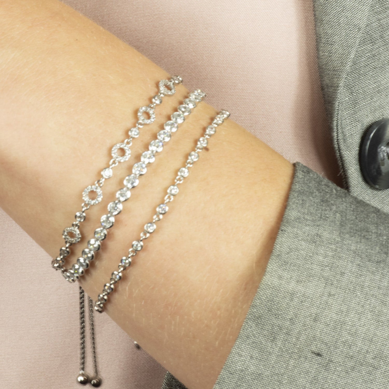 model wearing Five circle cubic zirconia silver bracelet, stacked for a layered look with other bracelets from our collection.