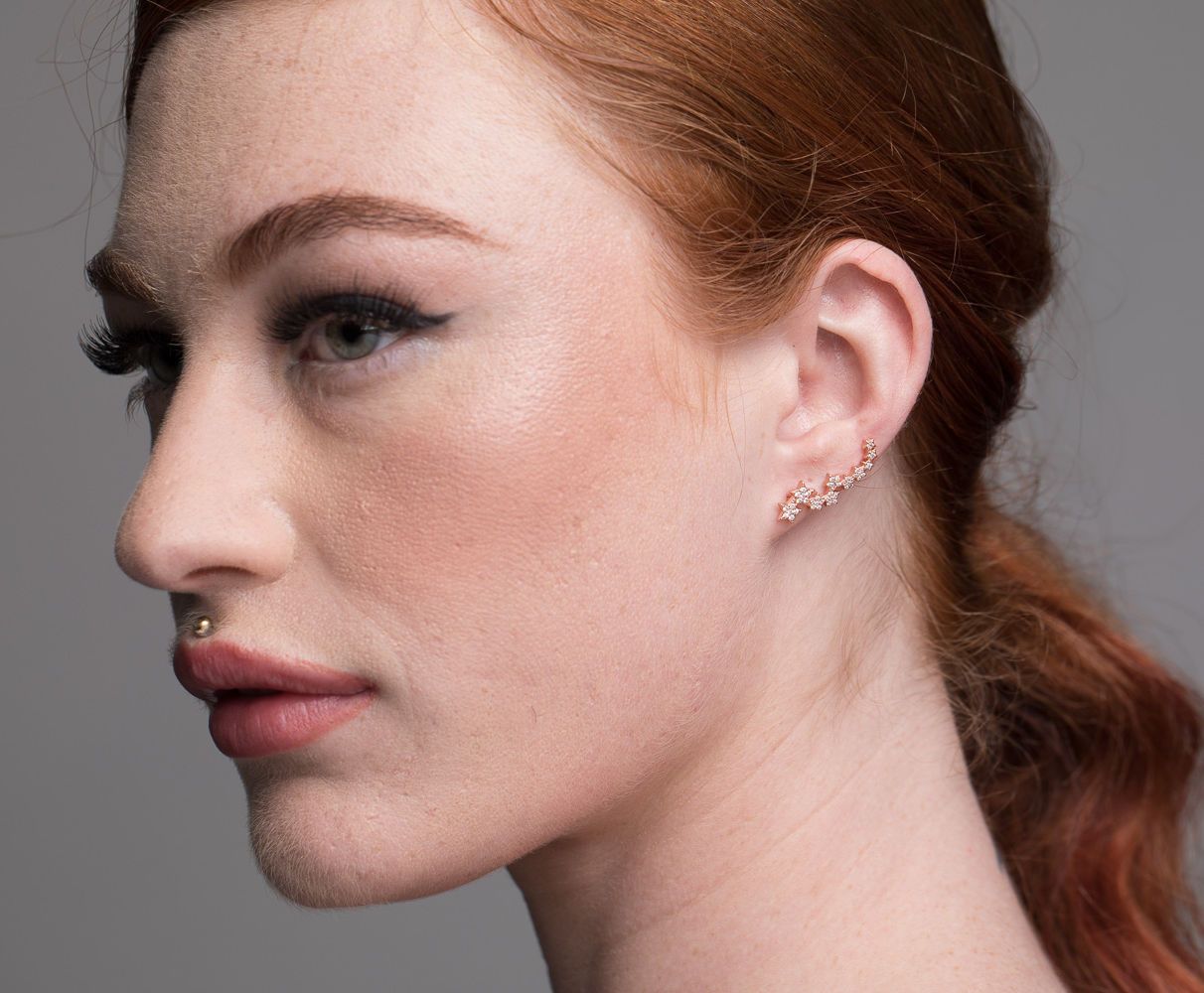 model wears beautiful star cuff earrings